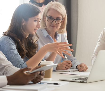 two females at computer discussing assessment data management