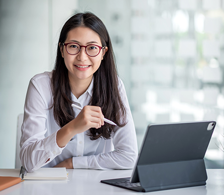 female teacher on laptop choosing assessment services