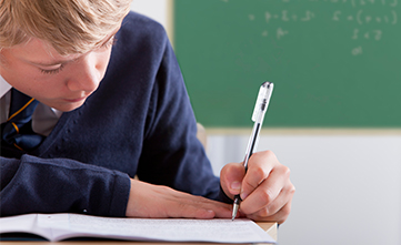 male student taking a school assessment
